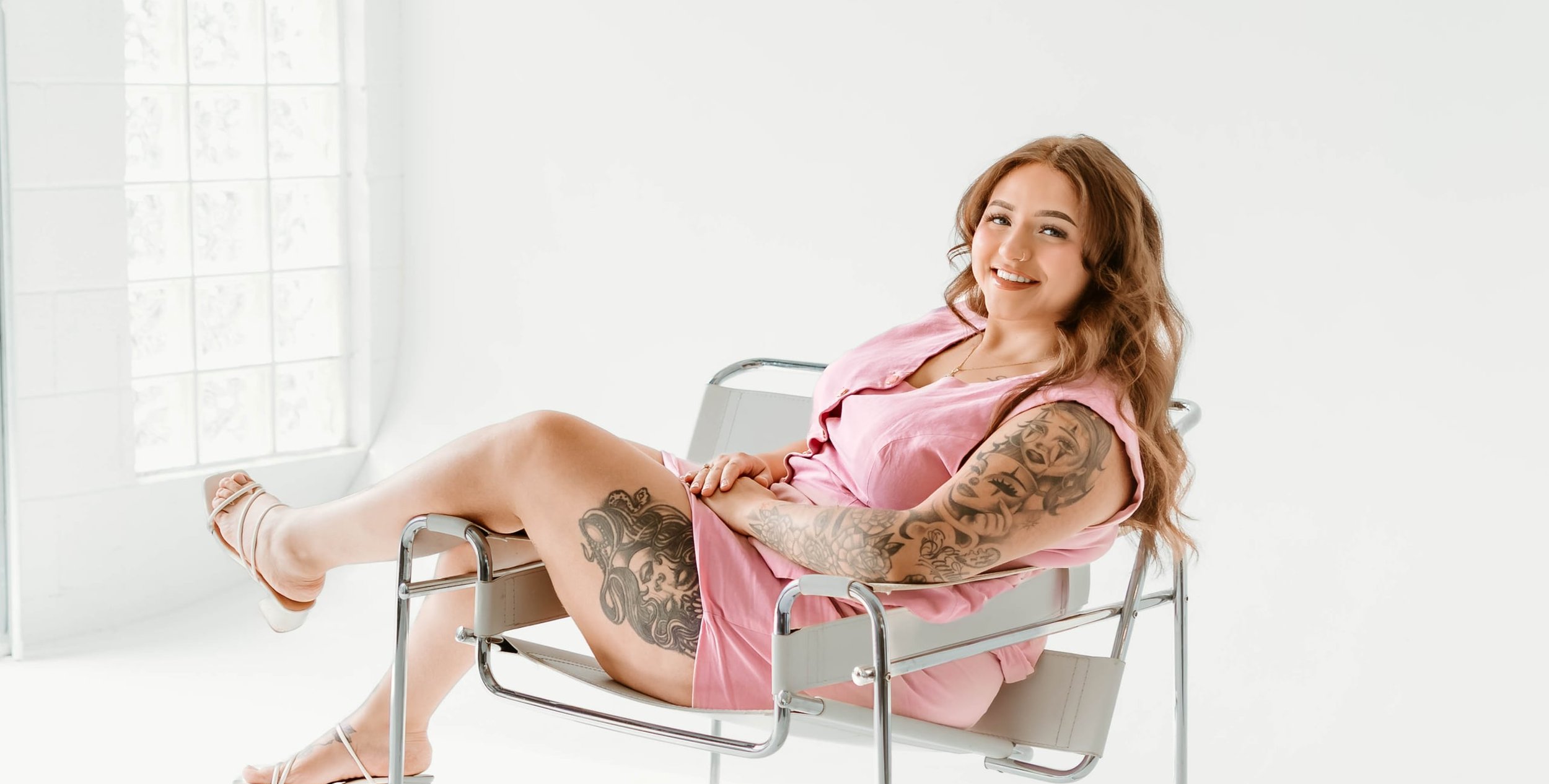 Gwen Johnson, owner and licensed esthetician at Geespot Aesthetics in Colorado Springs, seated in a bright studio